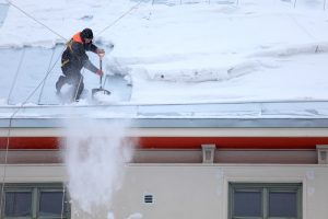 Pocatello roofing contractor working on snowy roof
